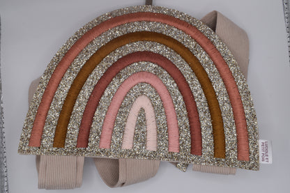 A rainbow hair clip holder. Glittery and wall hanging. Perfect for storage of girls hair clips. Top view of holder folded up 