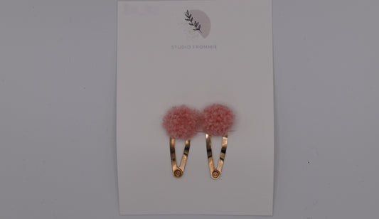 A set of two pompom hair clips for girls. Pink colour. Top view. Made by Studio Frommie