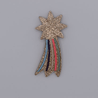 A glitter shooting star hair clip for girls. Pink and multicoloured. Top view without backing card. Made by Luciole et Petit Pois