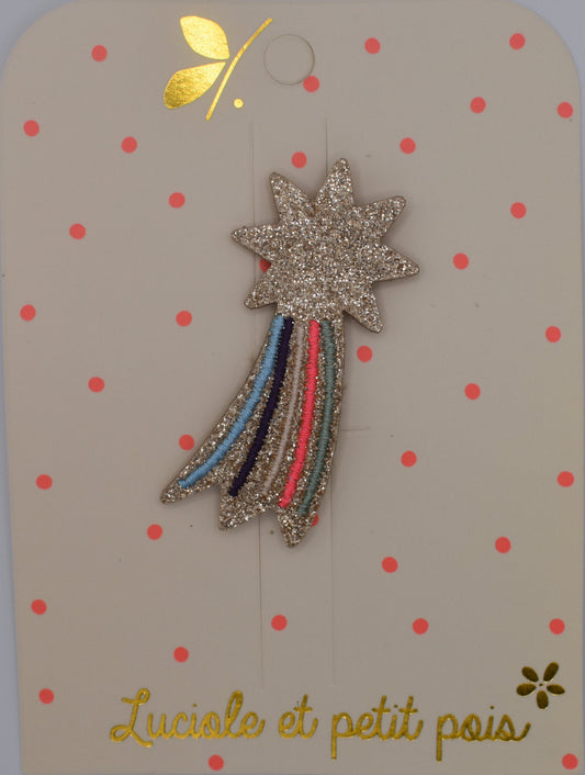 A glitter shooting star hair clip for girls. Pink and multicoloured. Top view. Made by Luciole et Petit Pois