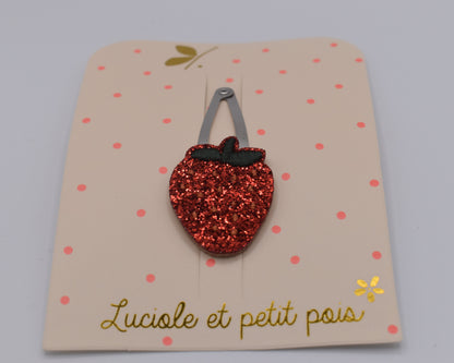 A glitter strawberry hair clip for girls. Red colour. Front view. Made by Luciole et Petit Pois
