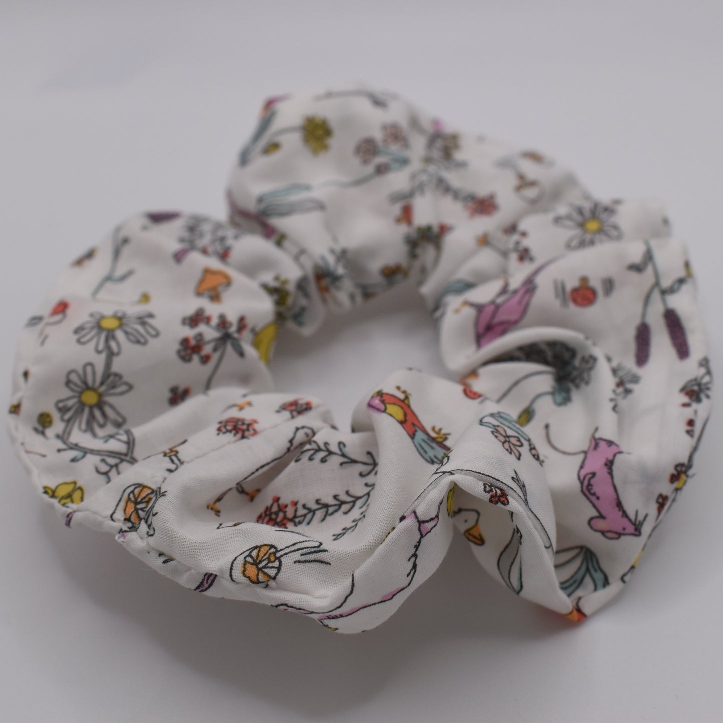 A girls hair scrunchie in Theo A Pink Liberty print. Made using Liberty Fabric by The Blossom Tree House. Front View