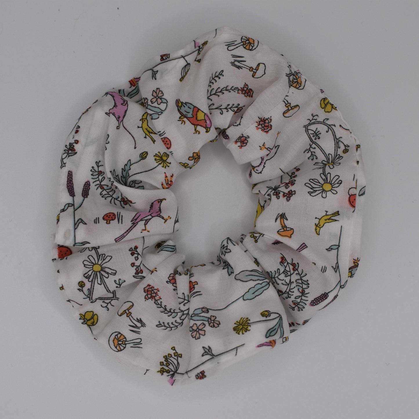 A girls hair scrunchie in Theo A Pink Liberty print. Made using Liberty Fabric by The Blossom Tree House. Top View