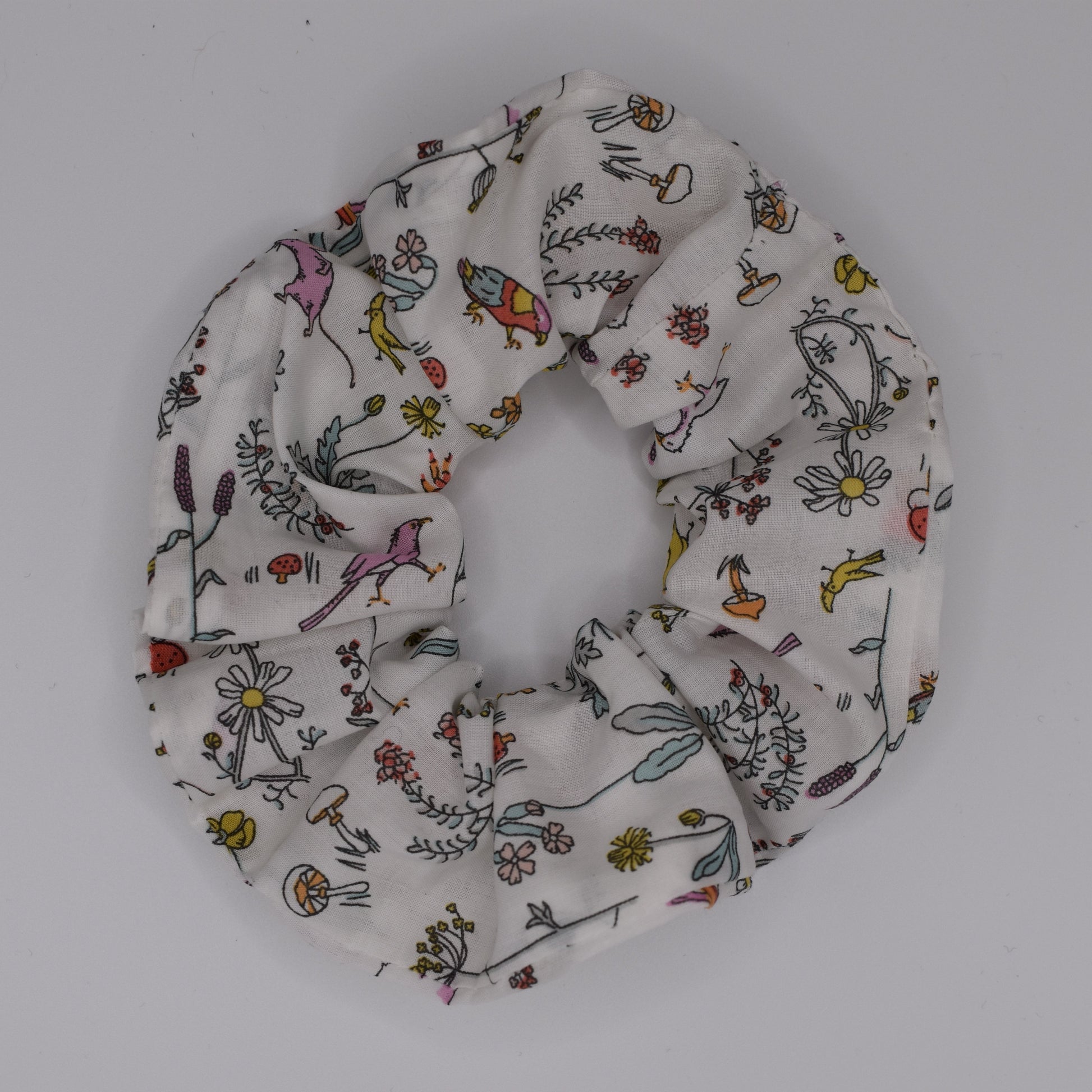 A girls hair scrunchie in Theo A Pink Liberty print. Made using Liberty Fabric by The Blossom Tree House. Top View