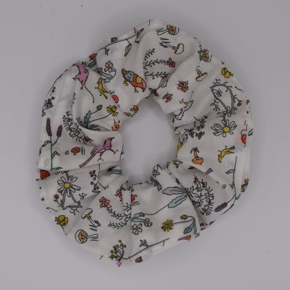 A girls hair scrunchie in Theo A Pink Liberty print. Made using Liberty Fabric by The Blossom Tree House. Top View