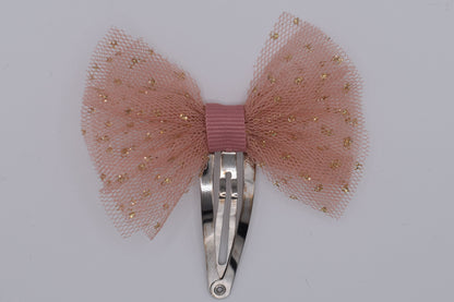 A tutu bow hair clip for girls. Pink fabric with gold sparkles. Top view without backing card. Made by Luciole et Petit Pois