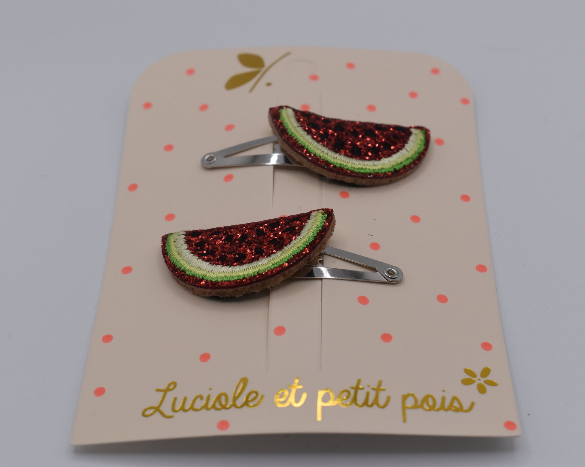 A pair of glitter watermelon hair clips for girls. Red and green colour. Front view. Made by Luciole et Petit Pois