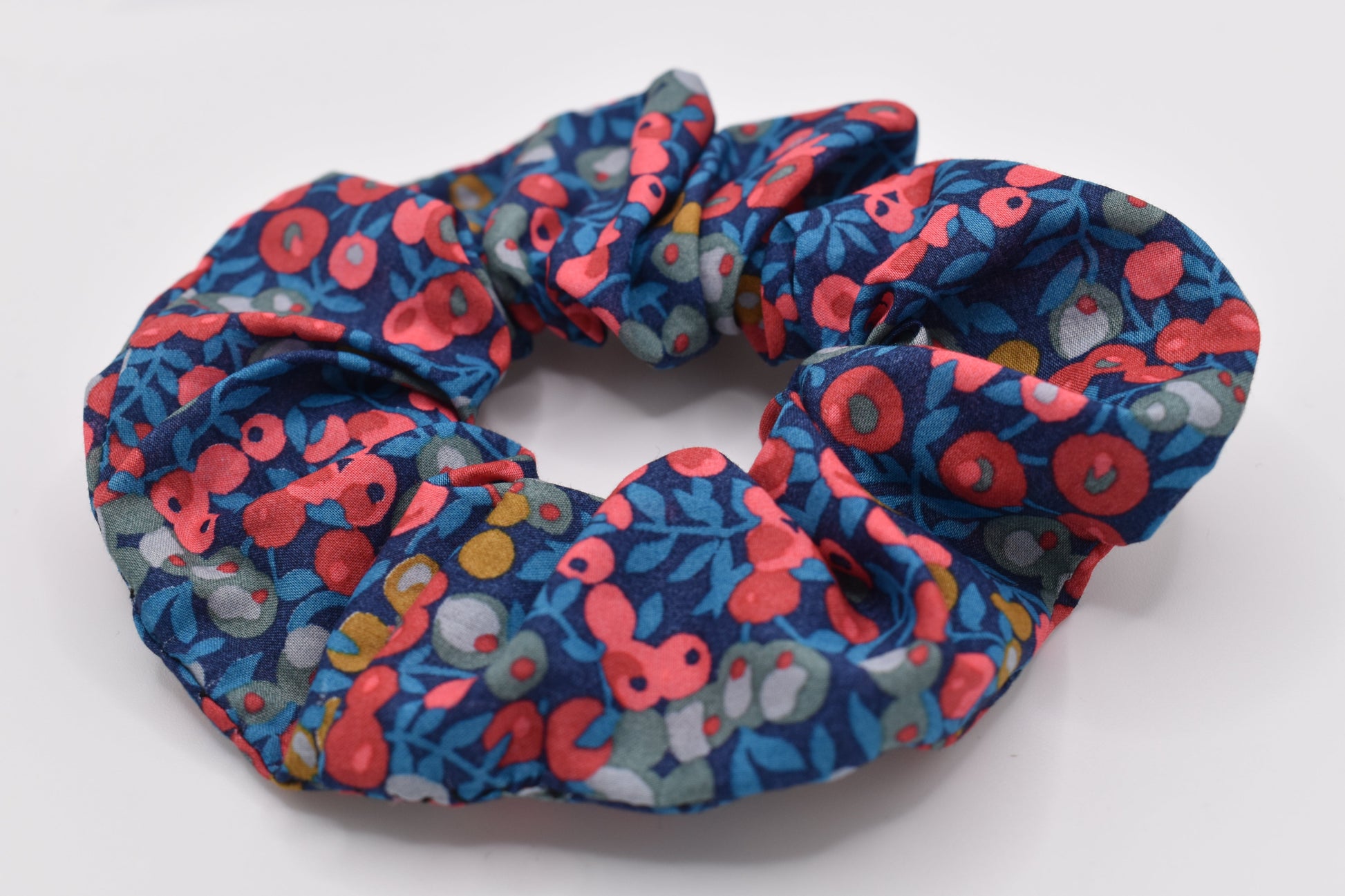 A classic Liberty fabric hair scrunchie for girls. Wiltshire Navy Red design, made in the UK by The Blossom Tree House. Front view
