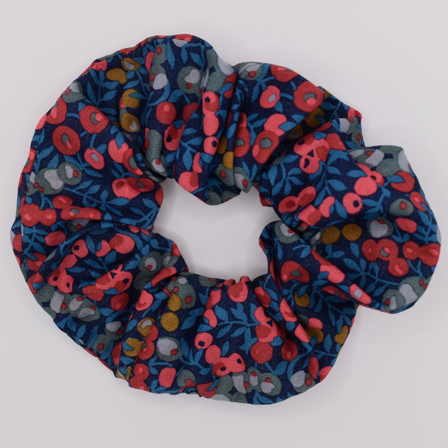A classic Liberty fabric hair scrunchie for girls. Wiltshire Navy Red design, made in the UK by The Blossom Tree House. Top view