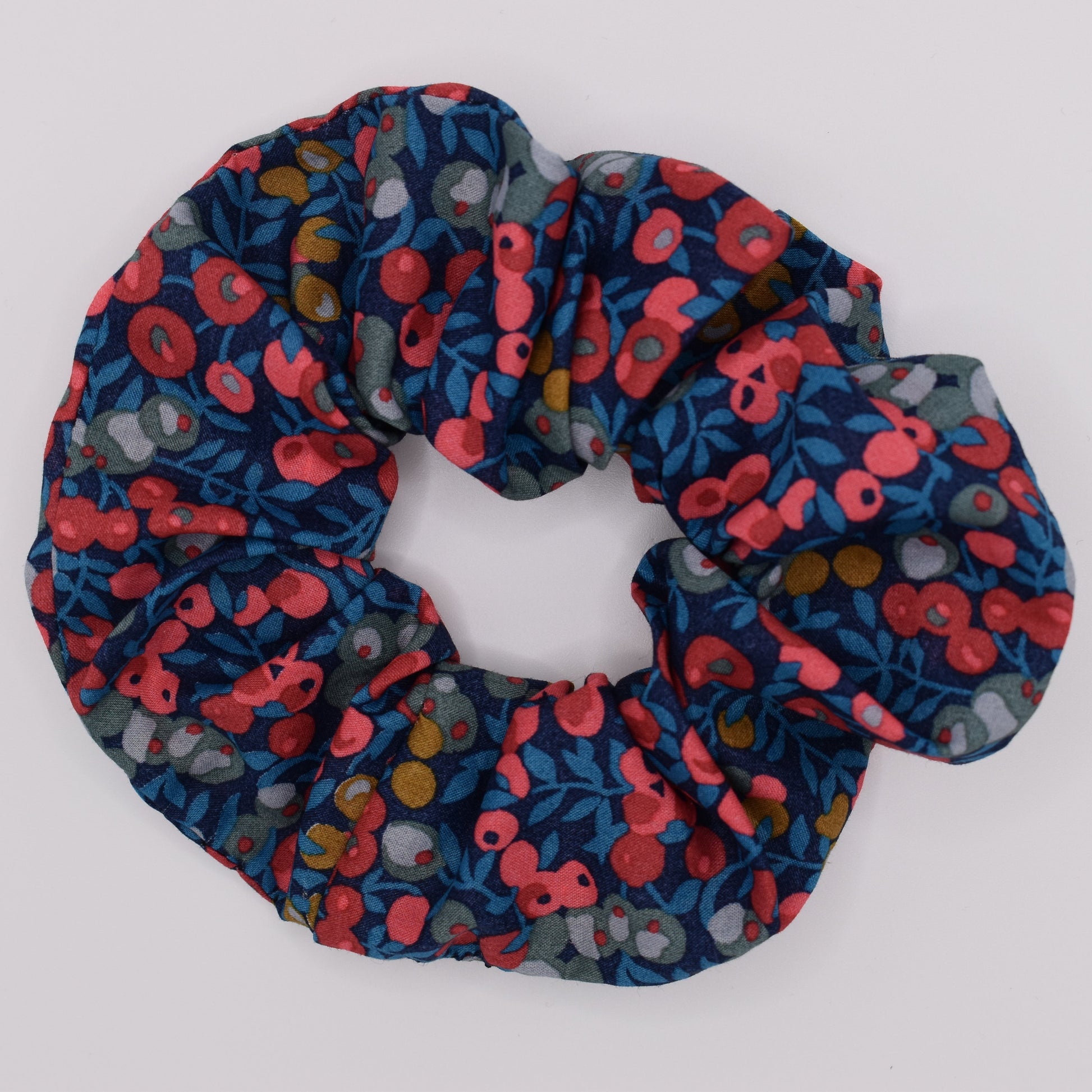 A classic Liberty fabric hair scrunchie for girls. Wiltshire Navy Red design, made in the UK by The Blossom Tree House. Top view